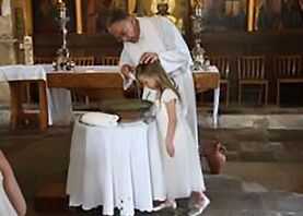 Picture of Child being Baptised by Rev'd Andrew